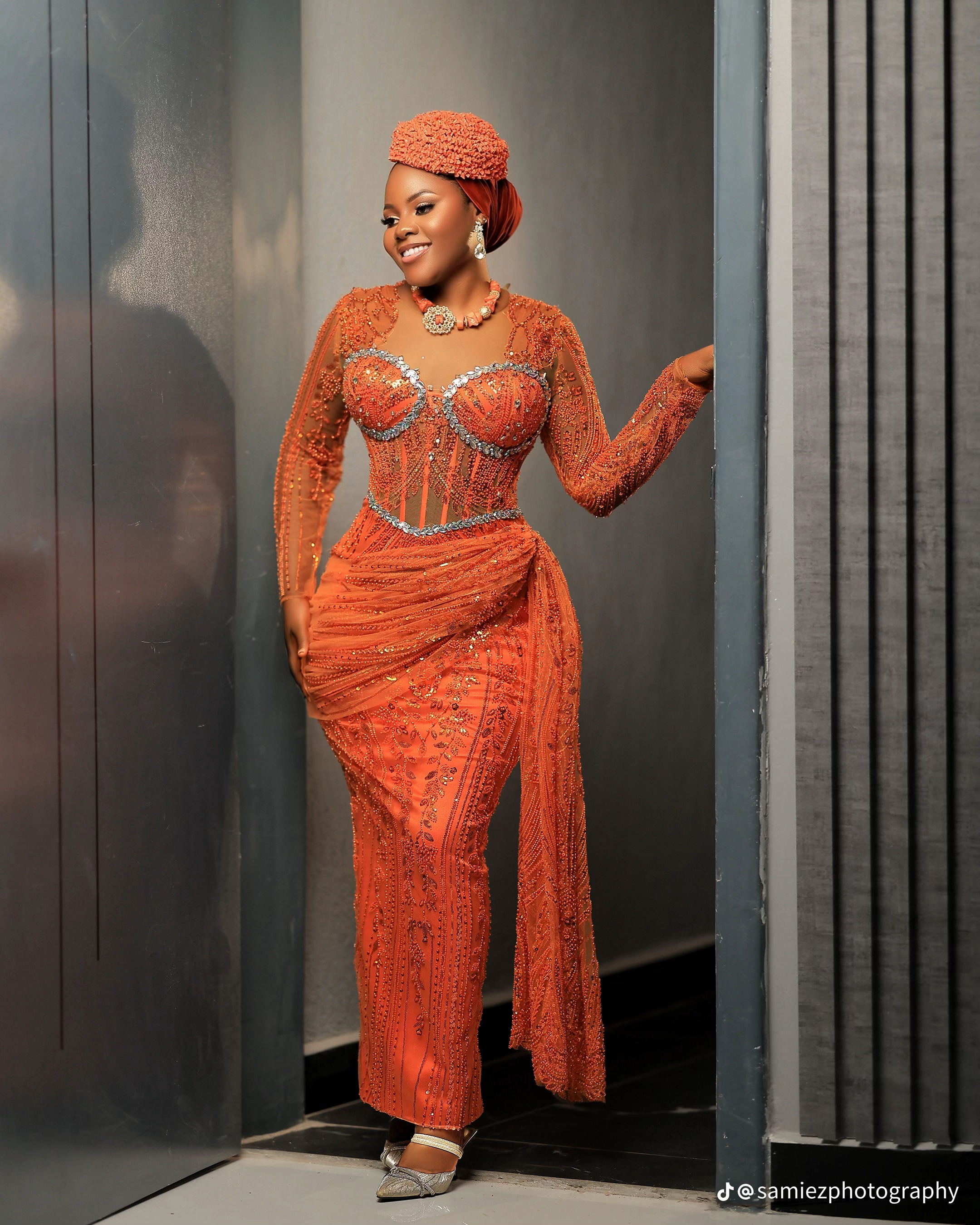 Full-length front view of the coral beaded gown