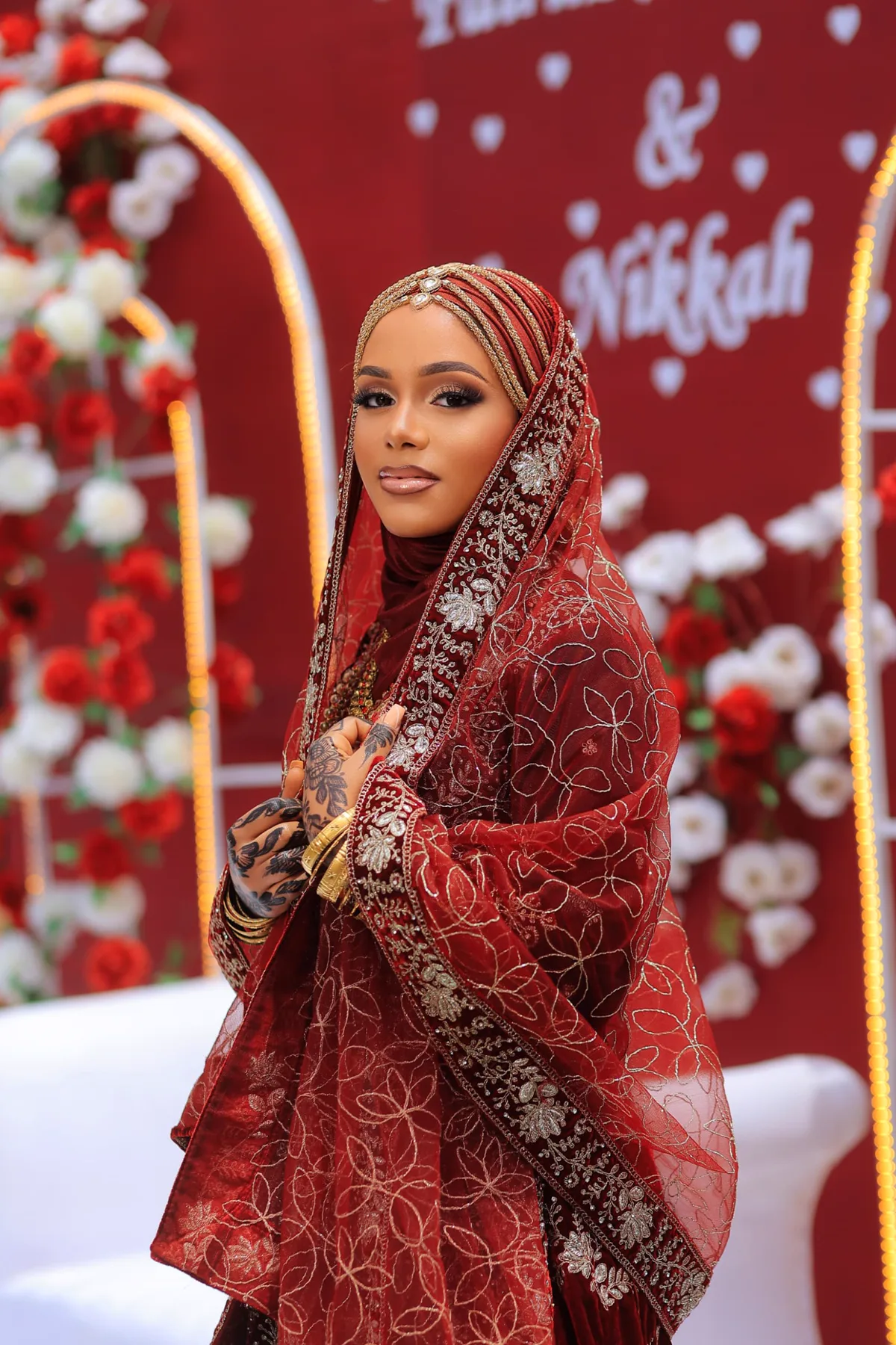Bride showing detailed henna with her ruby ceremony look
