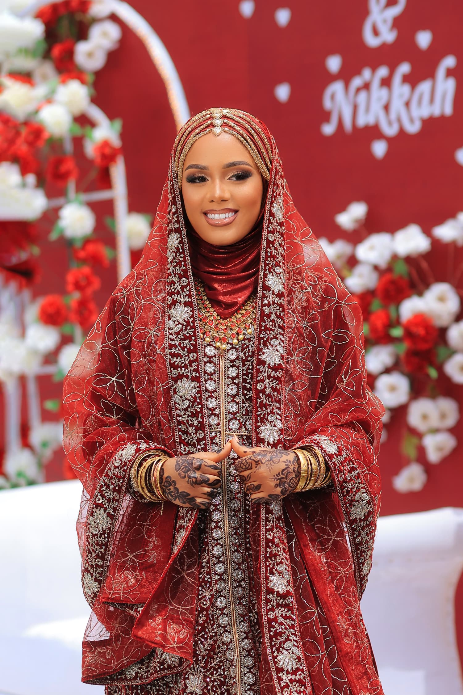Bride in the ruby Nikkah set with gold embroidery