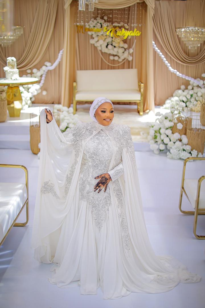 Full-length view of the ivory Amara beaded gown