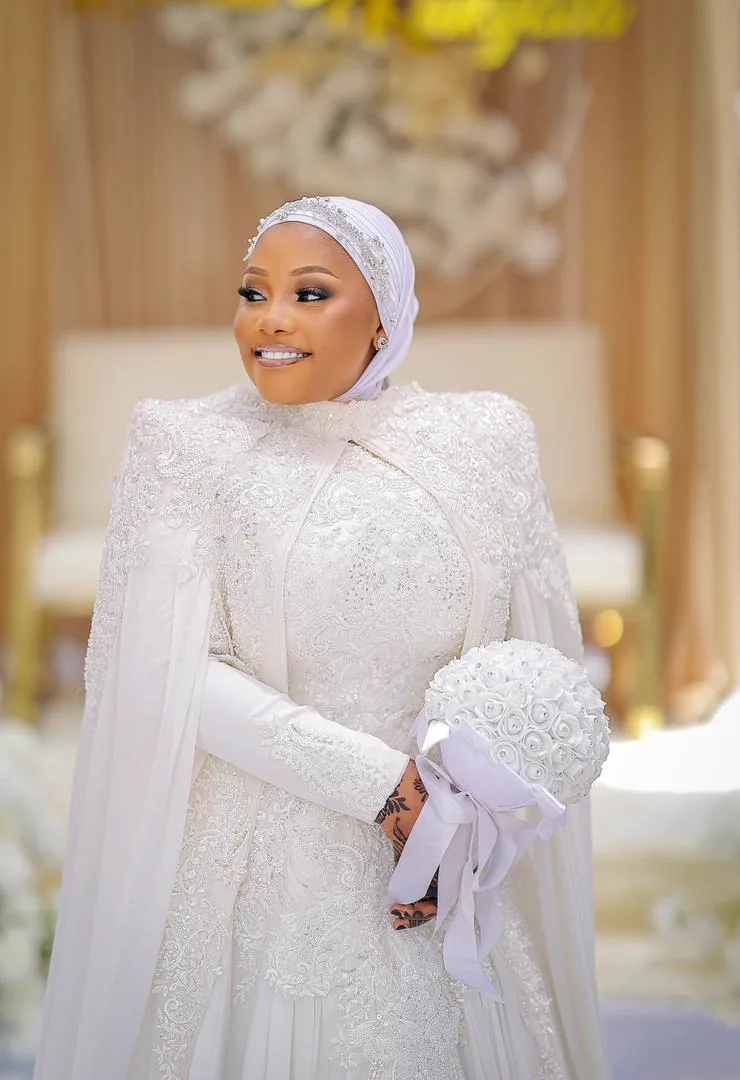 Bride in the ivory Noor modest gown and pearl-edged hijab